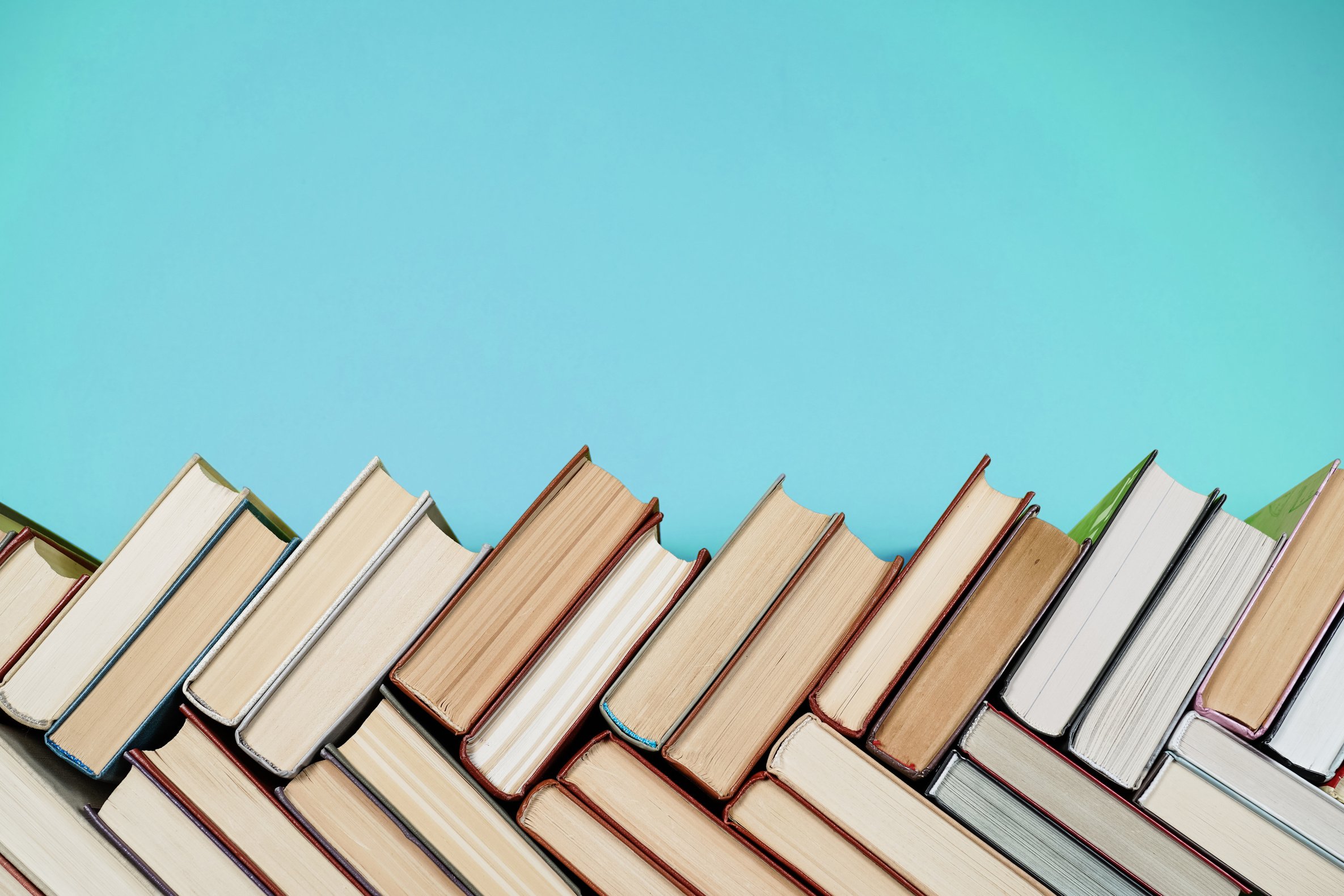 Many Books Piles. Hardback books on wooden table.